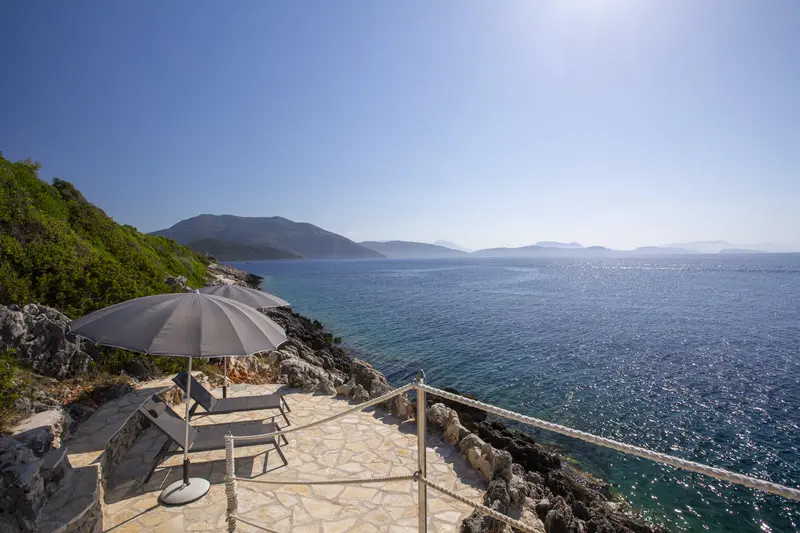 Stone bathing deck set into the rocks at the water line